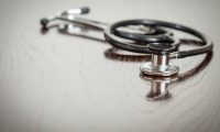 Doctor Stethoscope Laying on a Reflective Table
